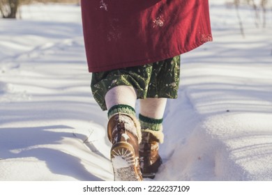 Close up legs in snow concept photo. Wintertime walk. Snowfall. Back view photography with snowdrifts on background. High quality picture for wallpaper, travel blog, magazine, article