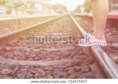 Close up legs of woman walking in railway. 