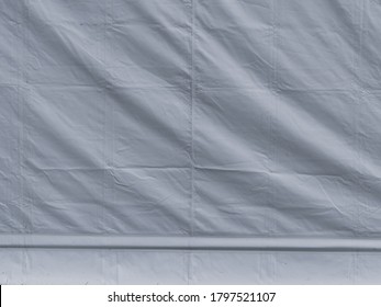 Close up of light background texture pattern white tarpaulin with creasings
