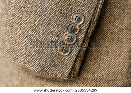 Close up of light brown woolen jacket with a sleeve fragment.