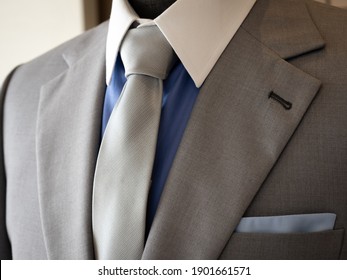 Close Up Of Light Grey Suit Jacket  With Blue Shirt White Collar Detail 