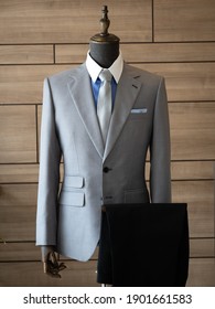 Close up of light grey suit jacket  with blue shirt white collar detail 