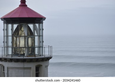 Close Up Of Light House On Oregon Coast With Waves And Sky In Background