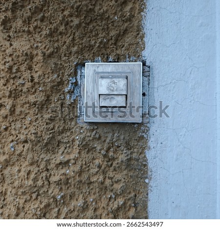 Close up of a light switch on a textured wall indoors