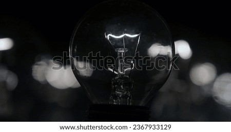 Close up of a lightbulb on a black background with copy space