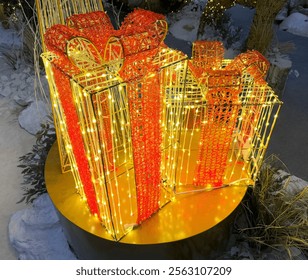 Close up of lighted christmas gift boxes with icicle lights or twinkle lights in red and yellow color. These lights are the symbol of joy and happiness. Seasons greetings - Powered by Shutterstock