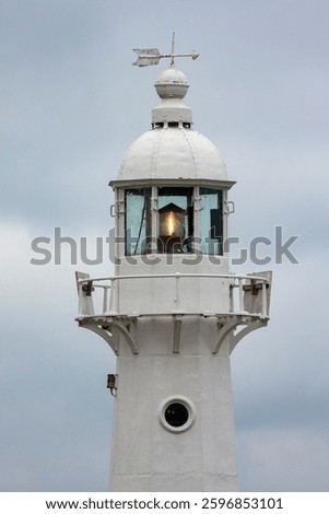 close up of lighthouse light at dusk