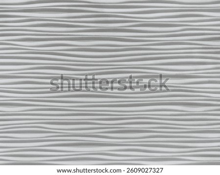 Close up of a linear wave pattern embossed on white background surface. 3D wall panel with wavy pattern. Seamless background texture.