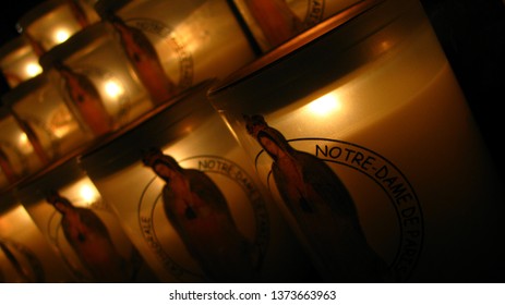 Close Up Of Lit Up Rows Of Candles With Image Of Saint Maria At The Notre Dame Cathedral, Paris, France Arranged And Displayed In Rows At The Church Before The Fire Hazard