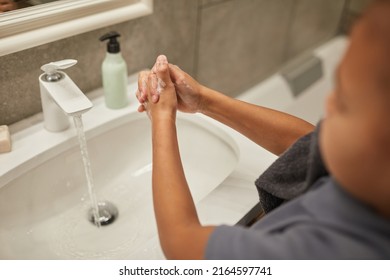 Close Up Of Little Black Girl Washing Hands In Bathroom Sink, Night Or Morning Hygiene, Copy Space