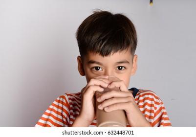 Close Up Of Little Boy Drinking Chocolate Milk 