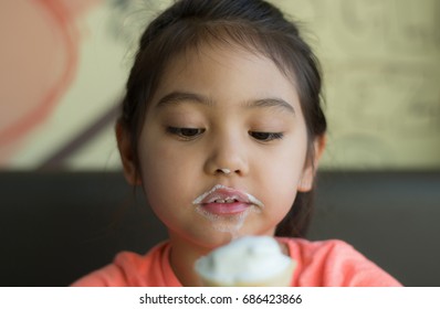 Close Up Little Girl Laughing And Eating Vanilla Soft Serve Ice Cream