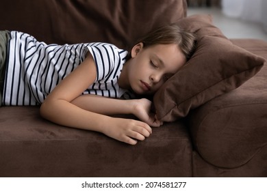 Close up little girl taking day nap, sleeping on cozy comfortable couch at home, cute adorable kid child with closed eyes lying resting on sofa, enjoying healthy sleep, falling asleep alone - Powered by Shutterstock