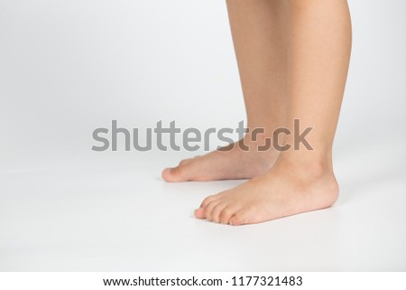 Close Up of a little girl's legs and feet Stand On a white background