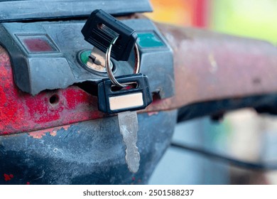 Close up of a lock on a bicycle with a key in it. Vintag of Motorcycle with blurred image. - Powered by Shutterstock