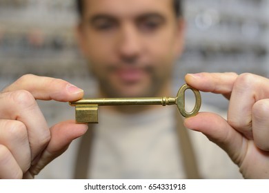 Close Up Of Locksmith Hands Holding Key