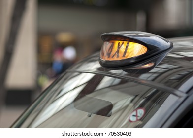 Close Up Of A London Black Cab With Yellow Light On.