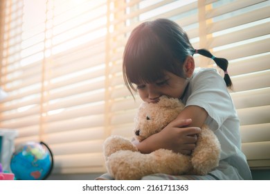 Close Up Lonely Little Girl Hugging Toy, Sitting At Home Alone, Upset Unhappy Child Waiting For Parents, Thinking About Problems, Bad Relationship In Family, Psychological Trauma