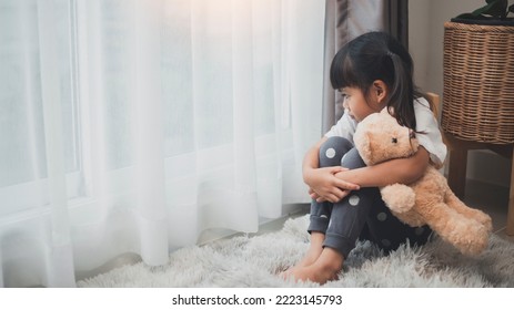 Close Up Lonely Little Girl Hugging Toy, Sitting At Home Alone, Upset Unhappy Child Waiting For Parents, Thinking About Problems, Bad Relationship In Family, Psychological Trauma