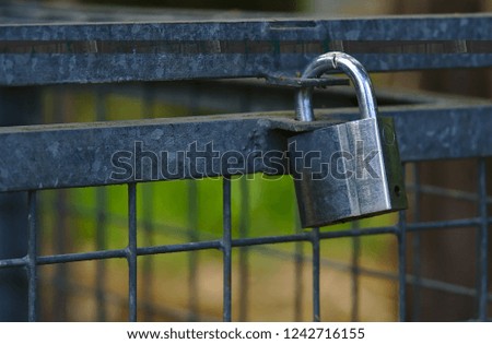 Close up look of silver padlock locking metal closure