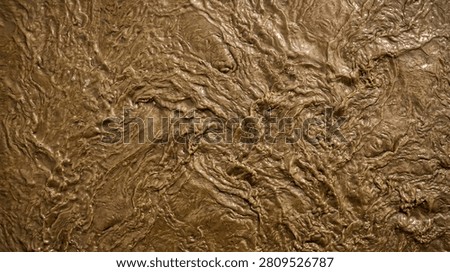 Close up look at thick muddy river water waves mixing and flowing dynamically