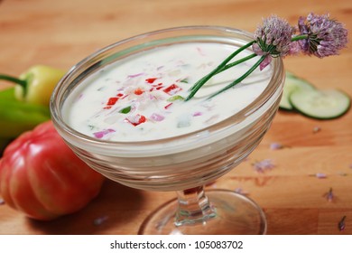 Close Up Look At White Gazpacho Soup Garnished With Purple Flowers