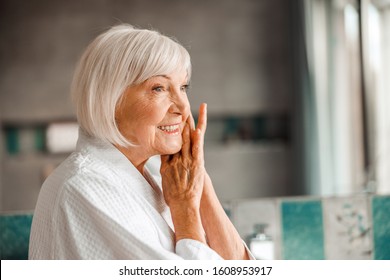 Close up of lovely elderly woman looking away and smiling stock photo. Website banner - Shutterstock ID 1608953917