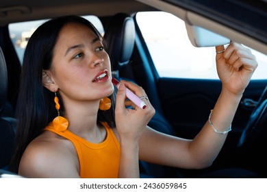 Close Up Lovely South American Woman Applying Red Lipstick Inside the Car Using The Mirror - Powered by Shutterstock