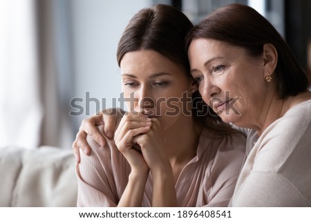 Close up loving mature mother calming comforting frustrated grownup daughter, expressing empathy and support, helping to overcome problems, caring elderly mum hugging frustrated young woman