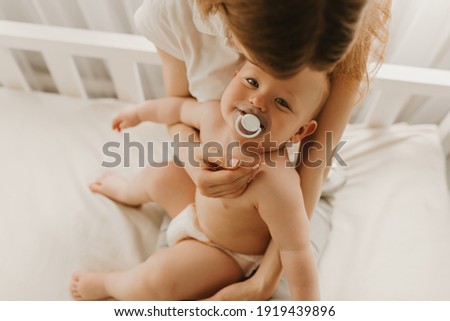 Similar – Mother hugging her newborn baby girl