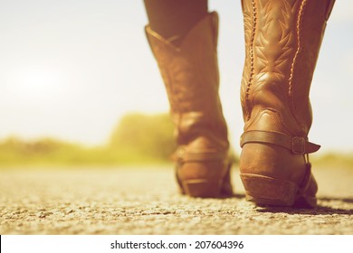 Close up low angle female with cowboy boots