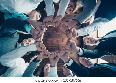 Close up low angle view photo members business people circle she her he him his hold hands arms fists together celebrate project prize nomination power inspiration dressed formal wear jackets shirts