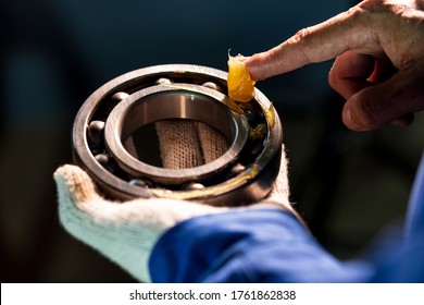 Close up of lubricant grease in hand Mechanic for putting into ball bearing in the industrial factory, Mechanic Industrial Concept - Shutterstock ID 1761862838