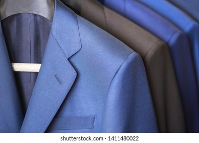 Close Up Luxurious Style Gentlemen Suit Row, Hanging In A Closet .