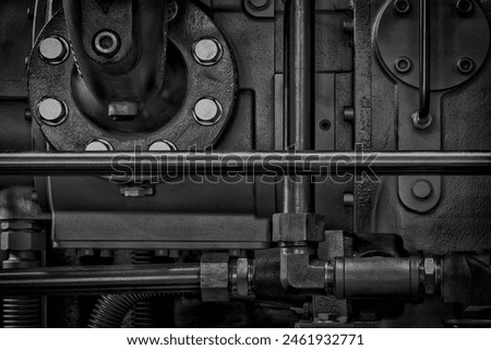 A close up of a machine with many bolts and nuts. Concept of complexity and intricacy, as well as the importance of the machine's inner workings