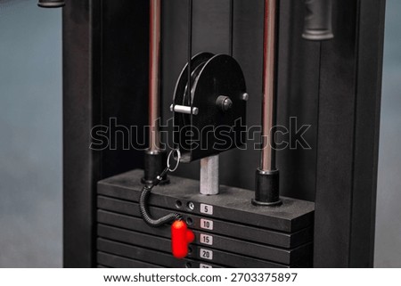 A close up of a machine with a red handle