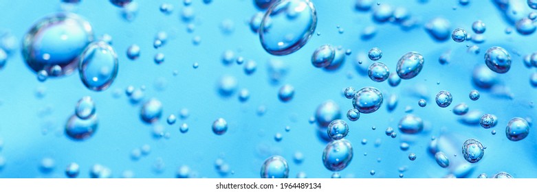 Close up macro Aloe vera gel cosmetic texture blue background with bubbles. Lemongrass gel skincare product. antibacterial liquid with aloe vera, moisturizing. Cruelty-Free Makeup