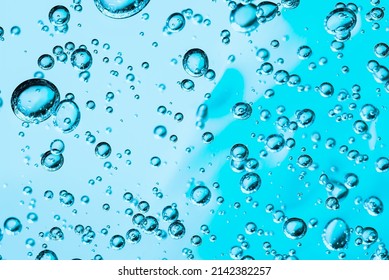Close up macro Aloe vera gel cosmetic texture blue background with bubbles. Lemongrass gel skincare product. antibacterial liquid with aloe vera, moisturizing. Serum texture. Hand sanitizer