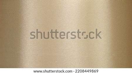 close up macro antique satin shine golden metallic silk smooth fabric ribbon texture abstract textile background with empty copy space.luxury celebrate concept,elegance fashion backdrop cover design.