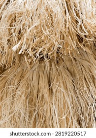 Close up macro texture background of natural dried straw fibers bound together.