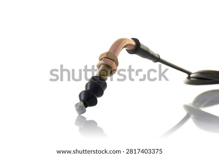 Close up macro view of motorcycle control cable end featuring yellow zinc plated threaded adjuster, hex locknuts, curved metal elbow tube, black rubber boot dust shield, and steel wire nipple, professional studio product photography shot on reflective white background.