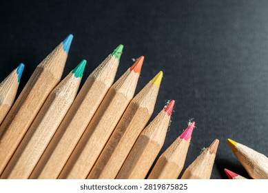 Close up macro view of sharp colorful pencil tips arranged neatly for an art project