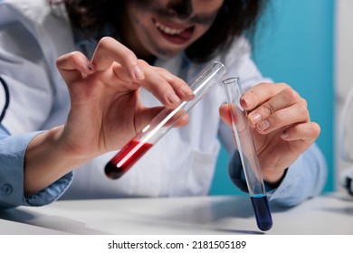 Close Up Of Mad Scientist Hands Mixing Experimental Liquid Chemical Compounds After Laboratory Explosion. Crazy Silly Lab Worker Doing Lab Work While Studying New Dangerous Substances. Studio Shot