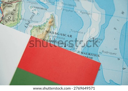 Close up of Madagascar flag on map of Madagascar.