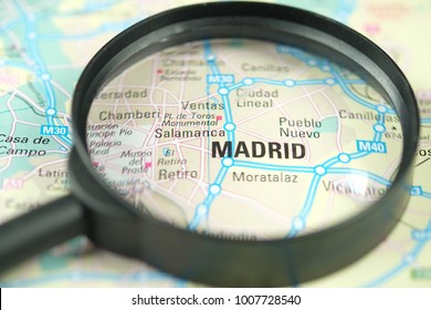 Close up of Madrid City under a magnifying glass on a map