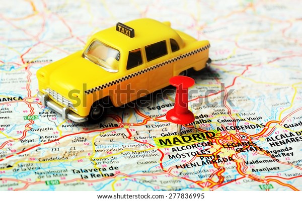 Close up of Madrid  ,Spain map , red pin and taxi
toy  - Travel concept