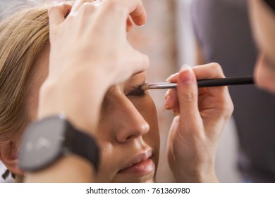 close up of makeup artist applying eyes make up