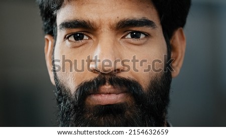 Close up male arabian bearded face handsome man with bright brown eyes looking at camera smiling toothy hispanic adult guy with healthy eyesight having good vision enjoy good news positive inspiration