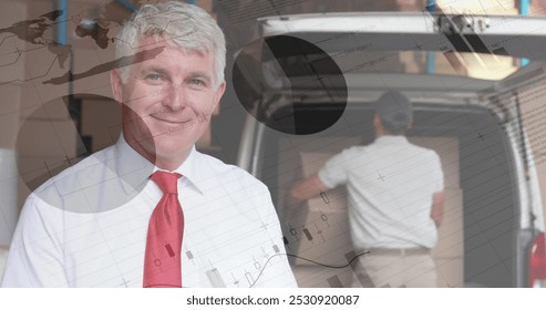 Close up of a male Caucasian warehouse manager smiling while holding a pen and a clipboard. Behind him is a deliveryman loading packages in a van. Digital image of graphs and statistics are running in - Powered by Shutterstock