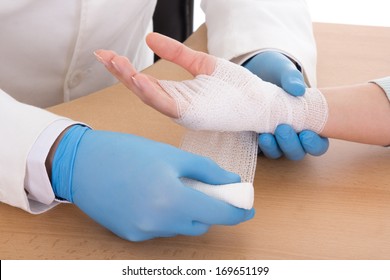 close up of male doctor bandaging female hand - Powered by Shutterstock